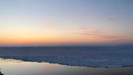 Fototapeta premium Sunset over the frozen sea in winter