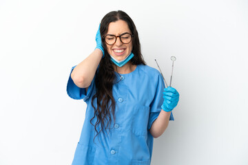 Young woman dentist holding tools isolated on white background frustrated and covering ears