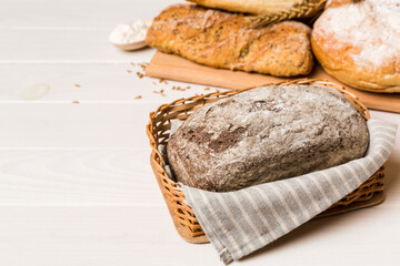 Homemade natural breads. Different kinds of fresh bread as background, perspective view with copy space