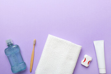 Mouthwash and other oral hygiene products on colored table top view with copy space. Flat lay. Dental hygiene. Oral care products and space for text on light background. concept