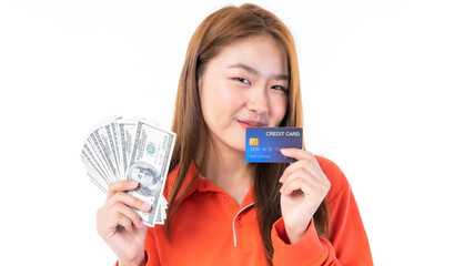Beautiful Asian young woman smiling happily in one hand , held a large amount of US dollars she had...