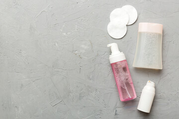 Micellar cleansing water and discs to remove cosmetics and cleanse the skin on colored background. Copy space top view