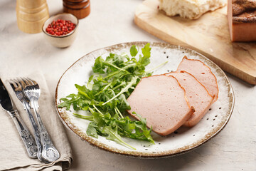 Traditional oven baked bavarian meal leberkäse sliced - meat dish made of corned beef, pork and...