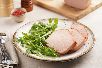 Traditional oven baked bavarian meal leberkäse sliced - meat dish made of corned beef, pork and...