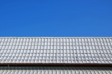 the white roof of the building and the blue sky