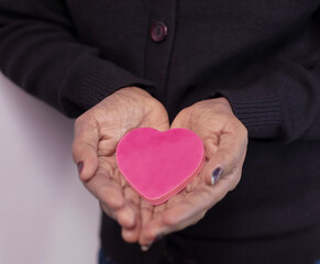 Close up portrait heart sign in hand 