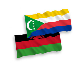 National vector fabric wave flags of Union of the Comoros and Malawi isolated on white background. 1 to 2 proportion.