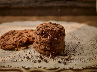 Dark chocolate cookies home made stacked with chocolate chips on jute.