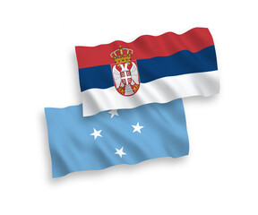 National vector fabric wave flags of Federated States of Micronesia and Serbia isolated on white background. 1 to 2 proportion.