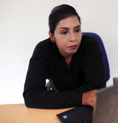Young lady looking on laptop with thinking mind, problem solving concept