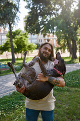 Fototapeta premium Smiling man holding in arms his Kurzhaar dog