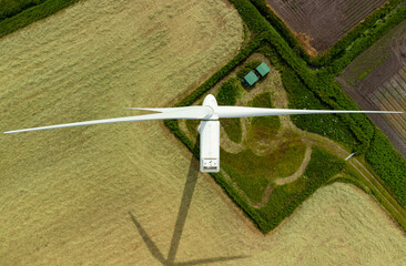 Aerial top down view of a wind turbine in a small rural wind farm in the English countryside