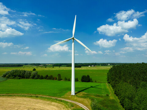 Aerial image of a wind turbine in a small rural wind farm in the English countryside