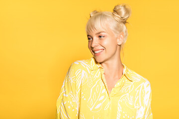  Smiling happy girl  wearing bright yellow  shirt and posing in studio. Stylish  and summer concept. Isolated on yellow background
