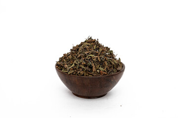 Dry mehndi leaves or henna mehendi or lawsonia inermis in wooden bowl on white background