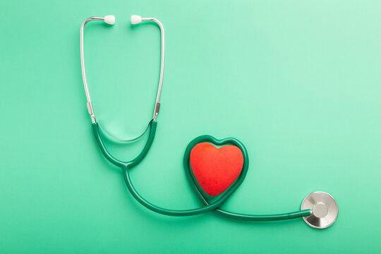 Healthcare and healthy lifestyle concept. Top above overhead close up view photo of black stethoscope and small red heart isolated over table background with copy blank empty space