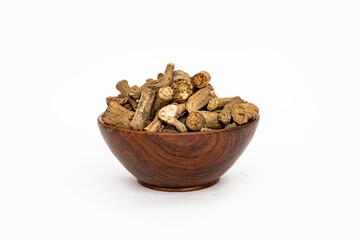Ayurvedic herb or folk medicine Hemidesmus indicus or Nannari or Indian sarsaparilla dried roots in wooden bowl