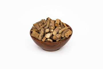 Ayurvedic herb or folk medicine Hemidesmus indicus or Nannari or Indian sarsaparilla dried roots in wooden bowl