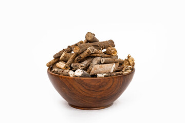 Ayurvedic herb or folk medicine Hemidesmus indicus or Nannari or Indian sarsaparilla dried roots in wooden bowl