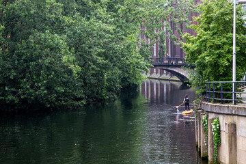Fototapeta na wymiar Paddleboarding on River Wensum, Norwich, Norfolk, UK