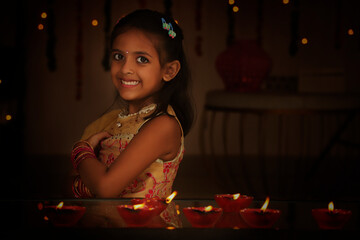 Happy girl standing arm crossed during Diwali festival night