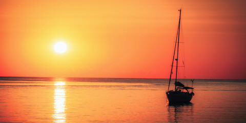 sailboat at sunset - 513130876