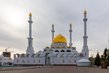 Fototapeta na wymiar Nur Astana Mosque (Nur Astana Meshiti) in Nur Sultan, Kazakhstan, with white facade and golden dome and ornaments.