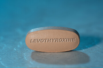 Obraz na płótnie Canvas Levothyroxine drug Pill Medication ob blue background