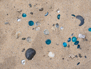 Sea glass and stone in sand background texture