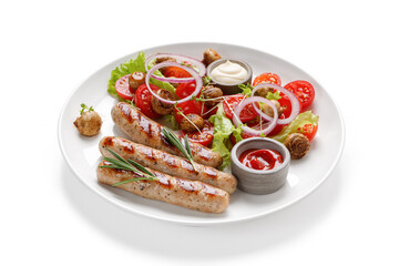 Grilled sausages with rosemary and salad with tomatoes on a plate isolated on white background.