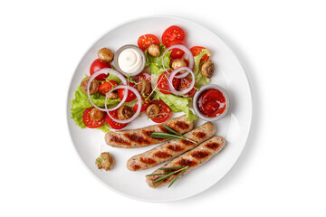 Grilled sausages with rosemary and salad with tomatoes on a plate isolated on white background....
