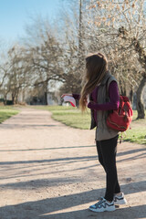 woman in city street looking on mask for face against coronavirus disease