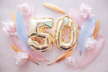Happy fiftieth birthday with golden number fifty 50 air balloons and blue feathers with colorful...