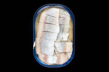 Herring fish in a metal jar isolated on a black background with clipping path. Top view. Herring in...