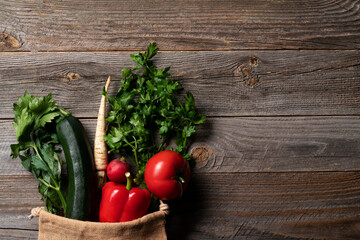 Beautiful fresh vegetables such us tomatoes, radish, parsley, brocoli and pepper straight from grocery farm shop in the reusable eco shopping bag.