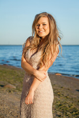 Fototapeta na wymiar Beautiful smiling young woman on summer beach