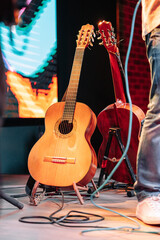 Two acoustic guitars on a guitar stand.