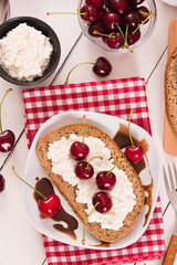 Rye bread with cottage cheese and cherries.