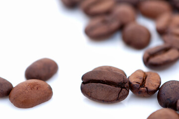 roasted coffee beans close up on a white background