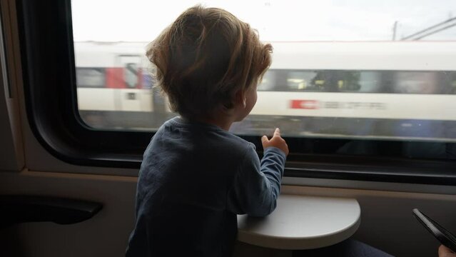 Adorable Child Traveling By Train Looking Out Through Window