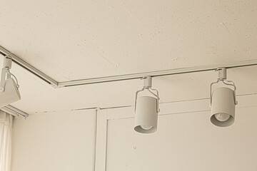 Spotlights under the ceiling on the wall.