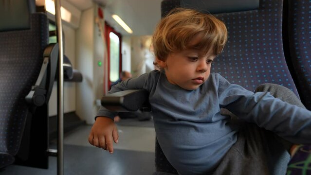 One Bored Child Sitting On Train Traveling Kid In Boredom