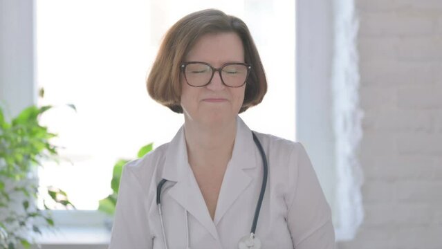 Senior Female Doctor Shaking Head as Yes Sign, Approval