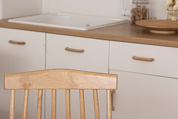 Modern Kitchen interior design with wooden chair.