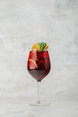 Cocktail with lime and fruit and mint on textured background