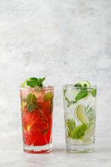 Cocktail with lime and fruit and mint on textured background