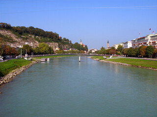 Fototapeta na wymiar Salzburg, embankment of the Salzach river, view of the city from afar. Austria