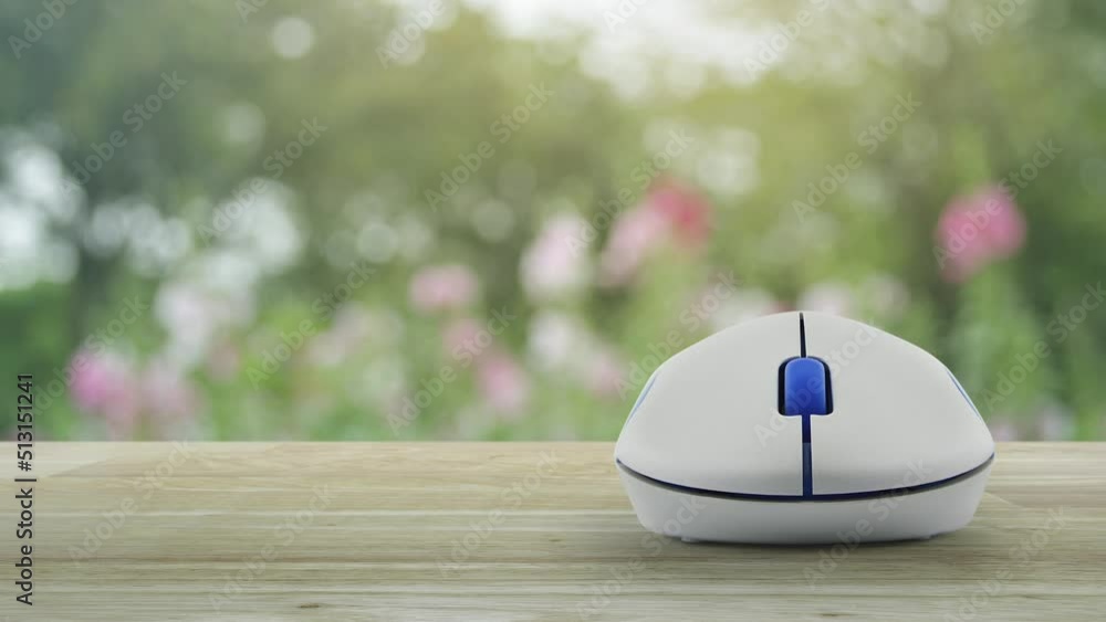 Poster e-learning flat icon with wireless computer mouse on wooden table over blur pink flower and tree in 