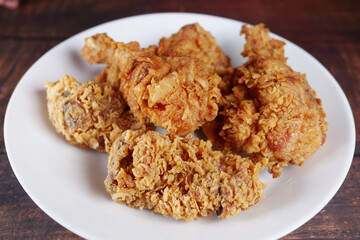 Crispy fried chicken on a plate top view .