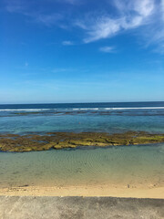 Sand beach in Bali with tropical sea and blue sky